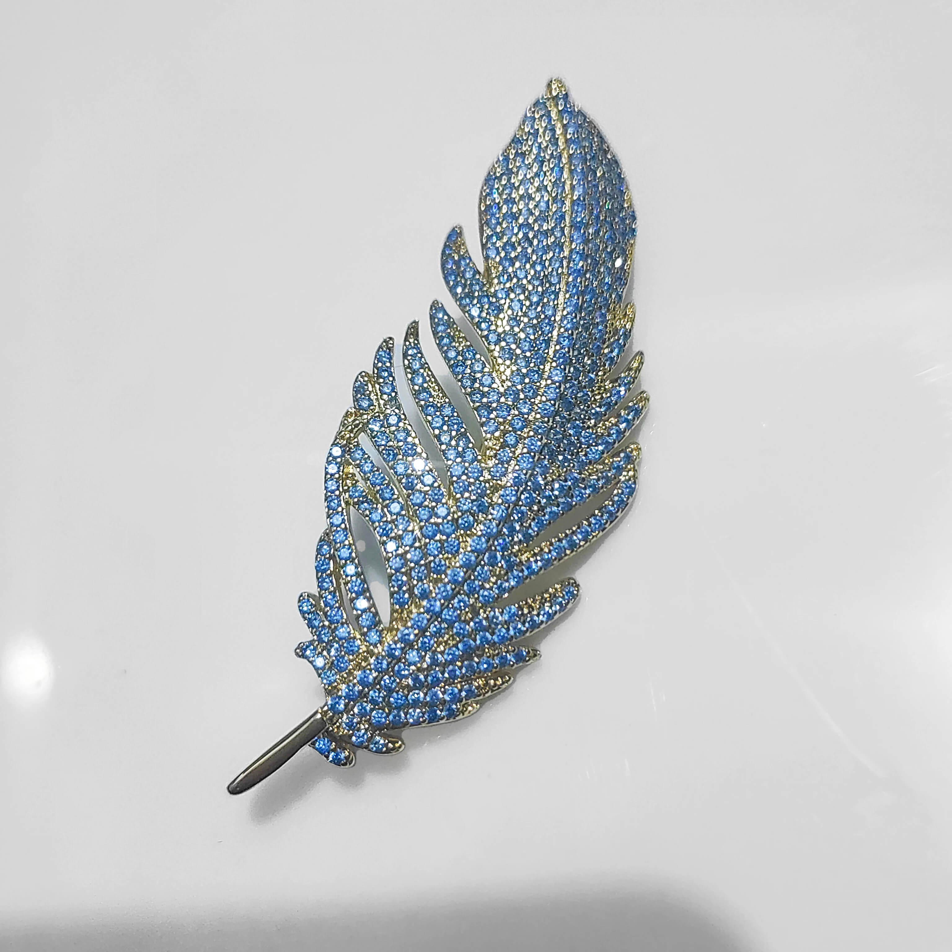 Copper Feather Brooch With Inlaid Micro Cubic Zirconia in Blue & Gold - Mounteen