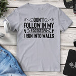 Don’t Follow In My Footsteps I Run Into Walls Tee. Shop Shirts & Tops on Mounteen. Worldwide shipping available.