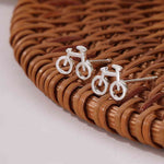 Dainty Silver Bicycle Earrings. Shop Earrings on Mounteen. Worldwide shipping available.