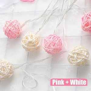 pink and white rattan ball string lights
